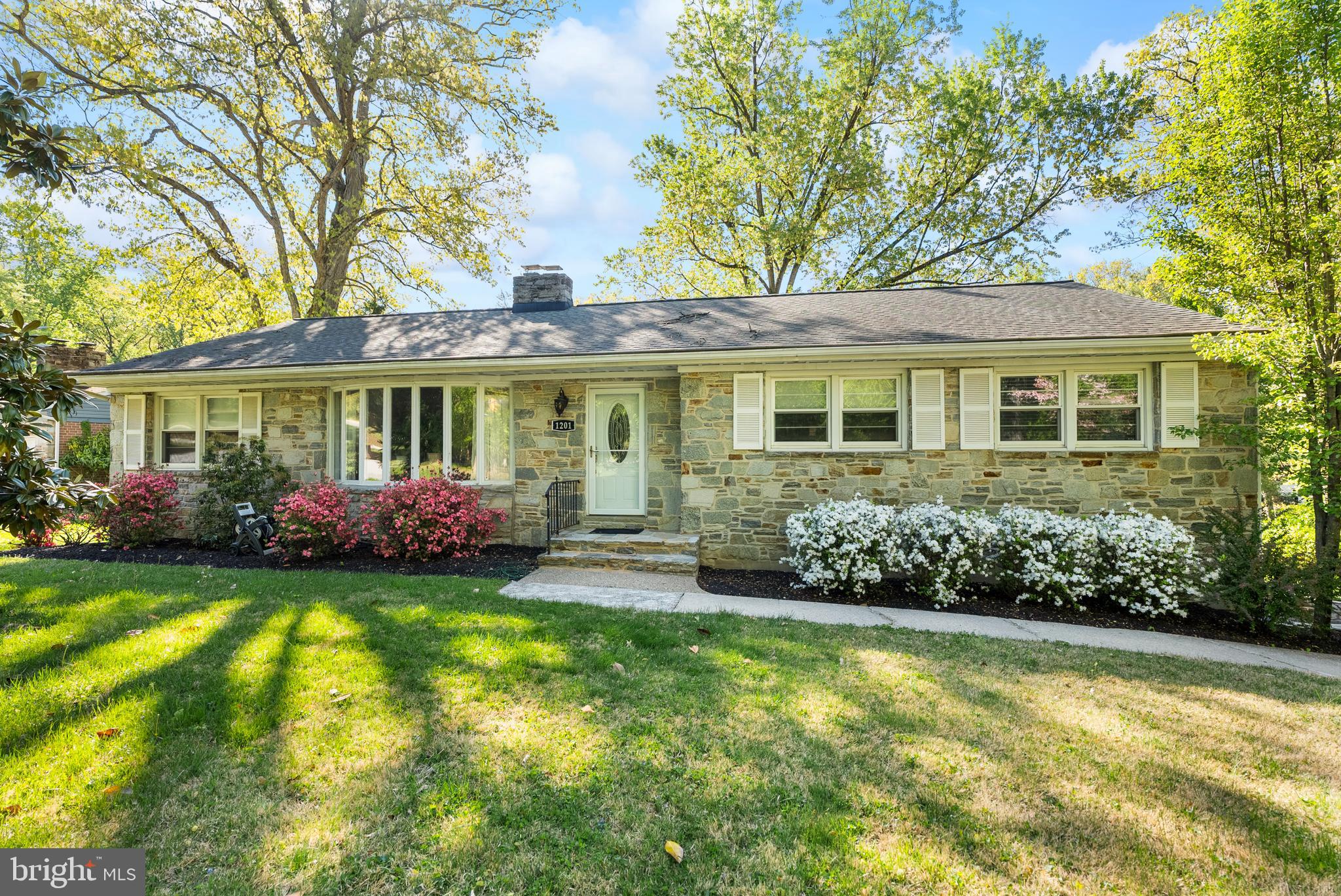 1201 Providence Road Towson, MD 21286 - Photo 1 of 35 a front view of a house with a garden and trees