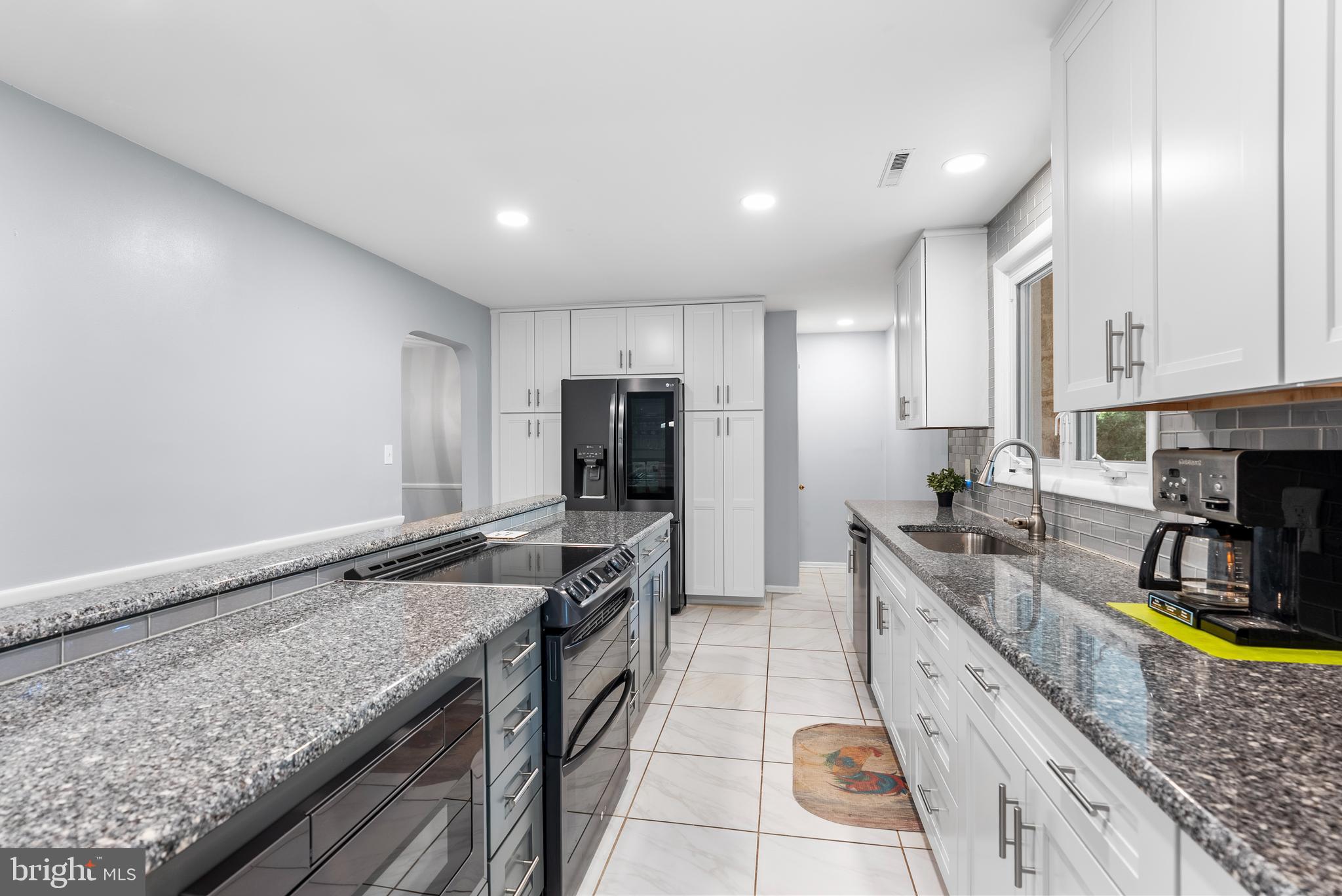 1201 Providence Road Towson, MD 21286 - Photo 11 of 35 a kitchen with a stove a sink a counter space and cabinets