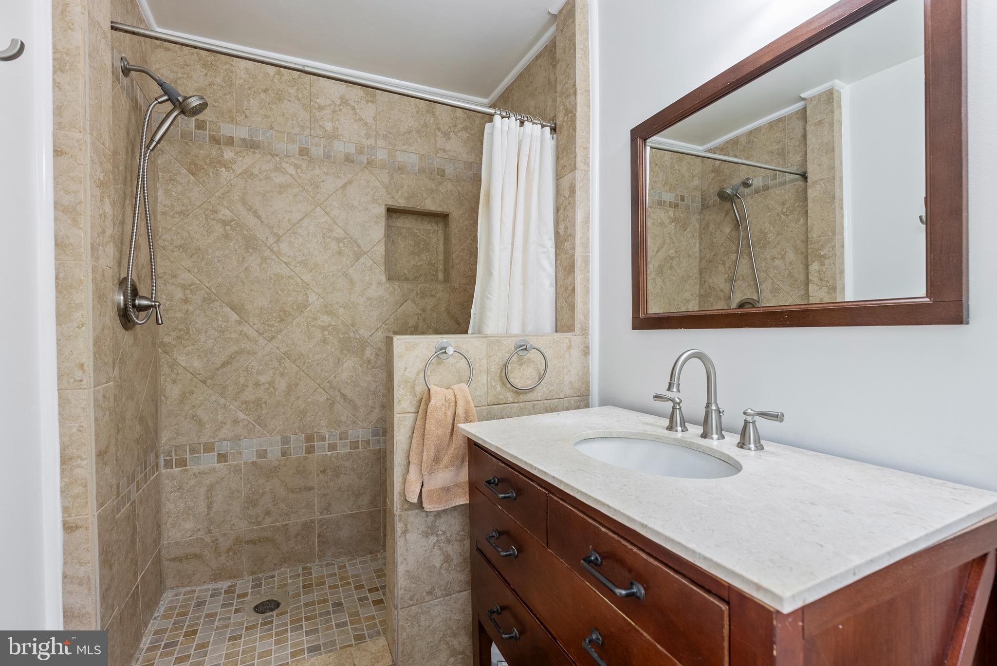 1201 Providence Road Towson, MD 21286 - Photo 15 of 35 a bathroom with a shower sink and mirror