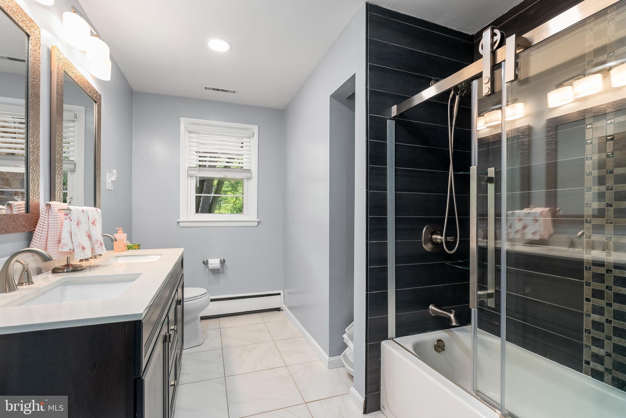 1201 Providence Road Towson, MD 21286 - Photo 18 of 35 a bathroom with a bathtub sink and mirror