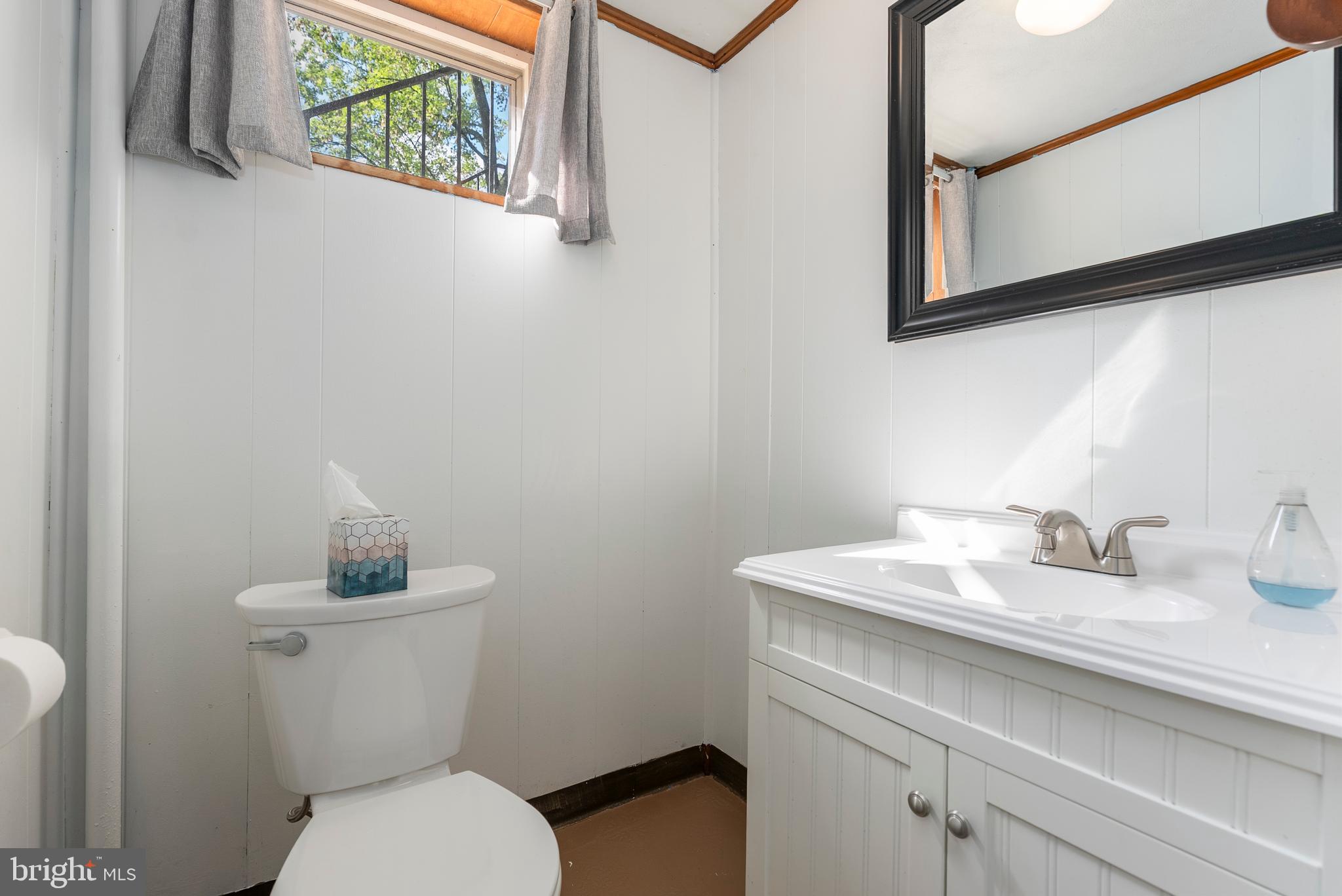 1201 Providence Road Towson, MD 21286 - Photo 27 of 35 a bathroom with a toilet sink and mirror