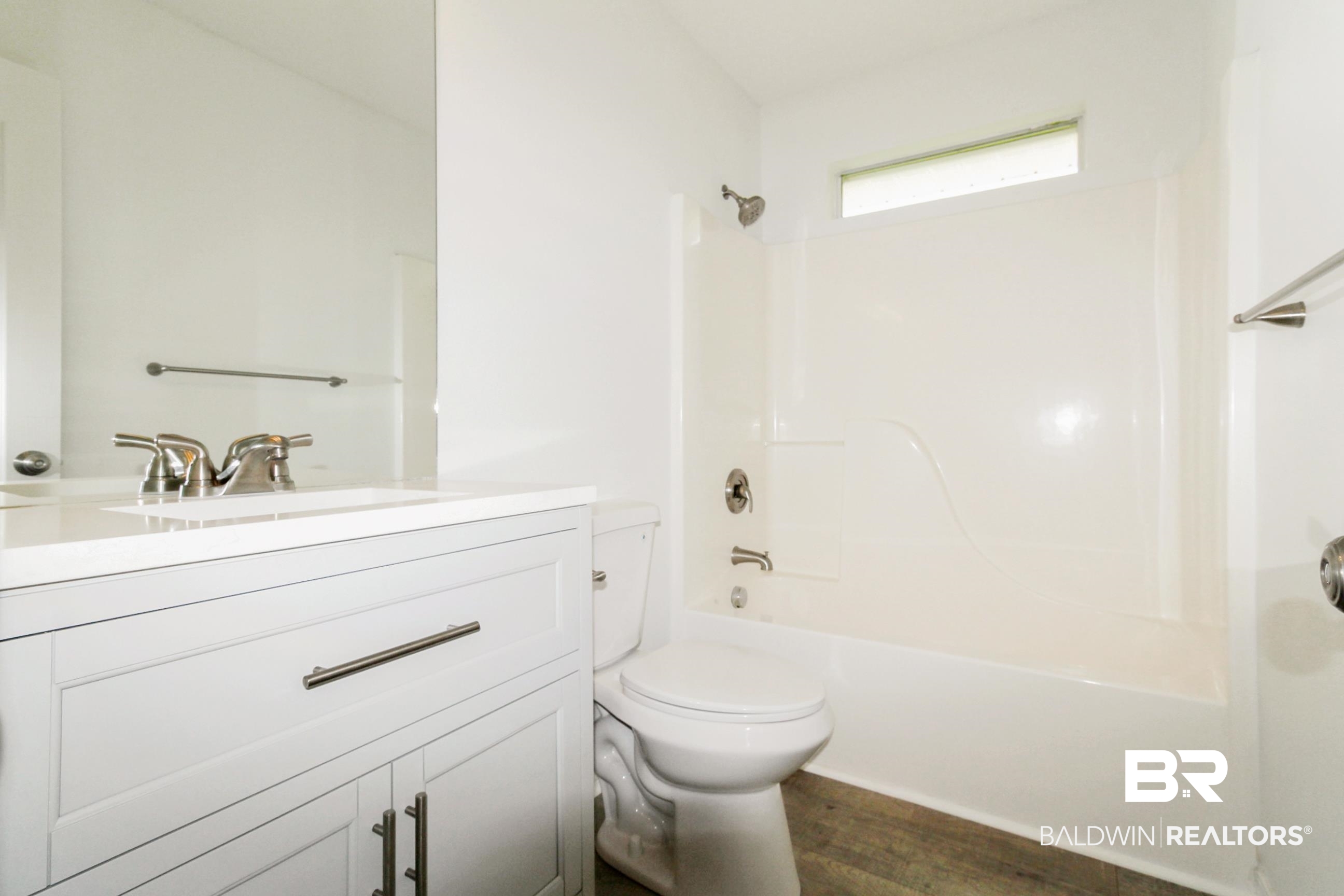 14750 Pawnee Court Foley, AL 36535 - Photo 29 of 34 Full bathroom featuring vanity, wood finished floors, and shower / washtub combination