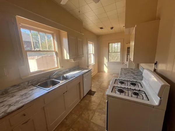 a kitchen that has a sink and a stove