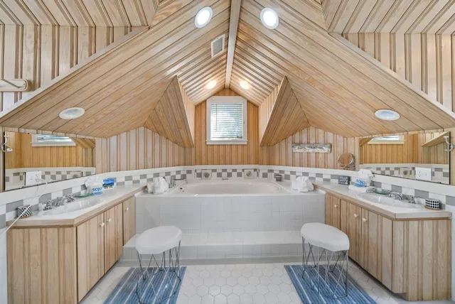 a bathroom with a granite countertop sink a toilet and shower