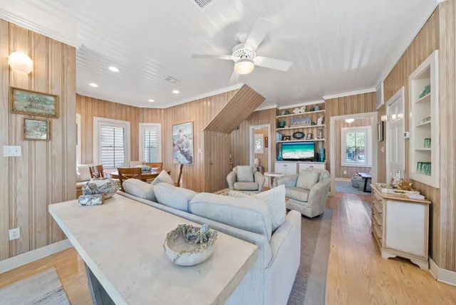a view of a dining room with furniture a livingroom and chandelier