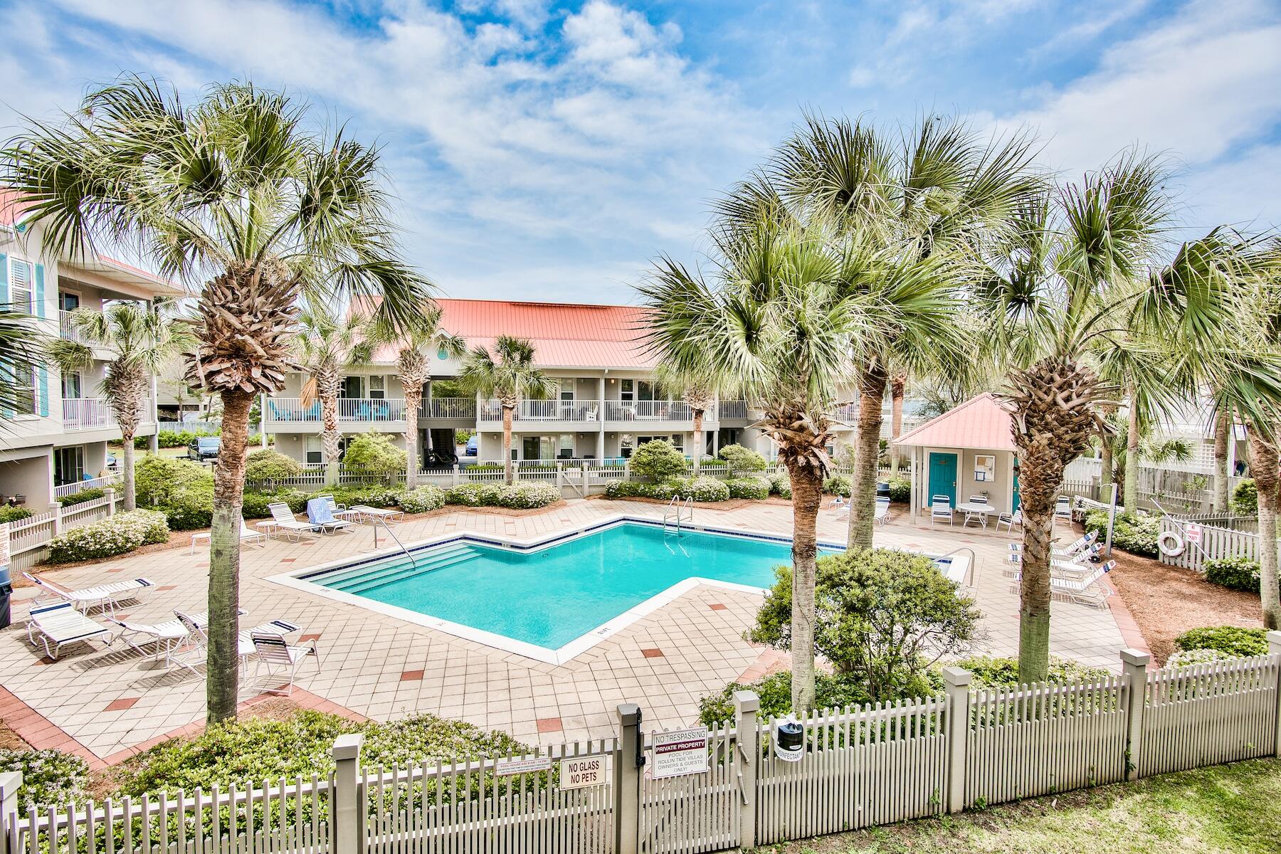 82 Sugar Sand Lane, Unit A7 Santa Rosa Beach, FL 32459 - Photo 18 of 35 a view of a white house with a yard table and chairs