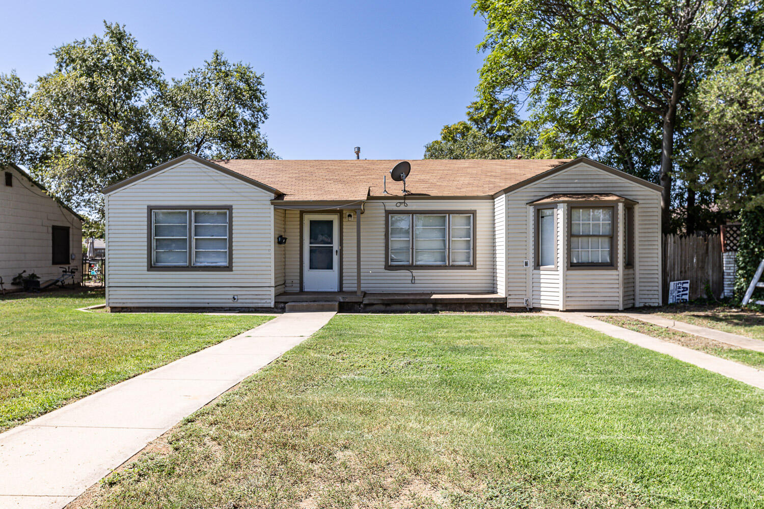 2417 37th Street Lubbock, TX 79412 - Photo 1 of 35 a front view of a house with a garden