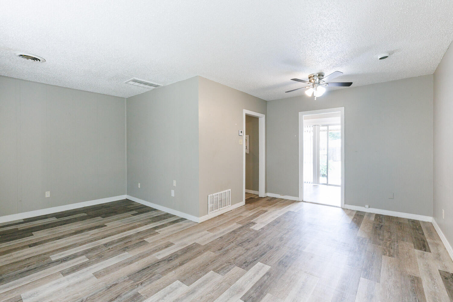 2417 37th Street Lubbock, TX 79412 - Photo 11 of 35 wooden floor in an empty room with a window
