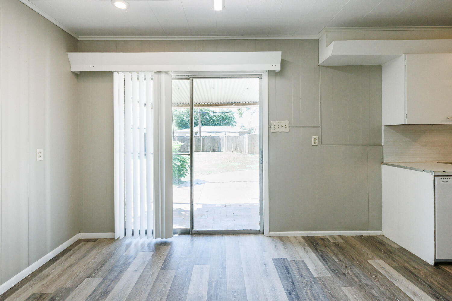 2417 37th Street Lubbock, TX 79412 - Photo 12 of 35 a view of an empty room with wooden floor and a window