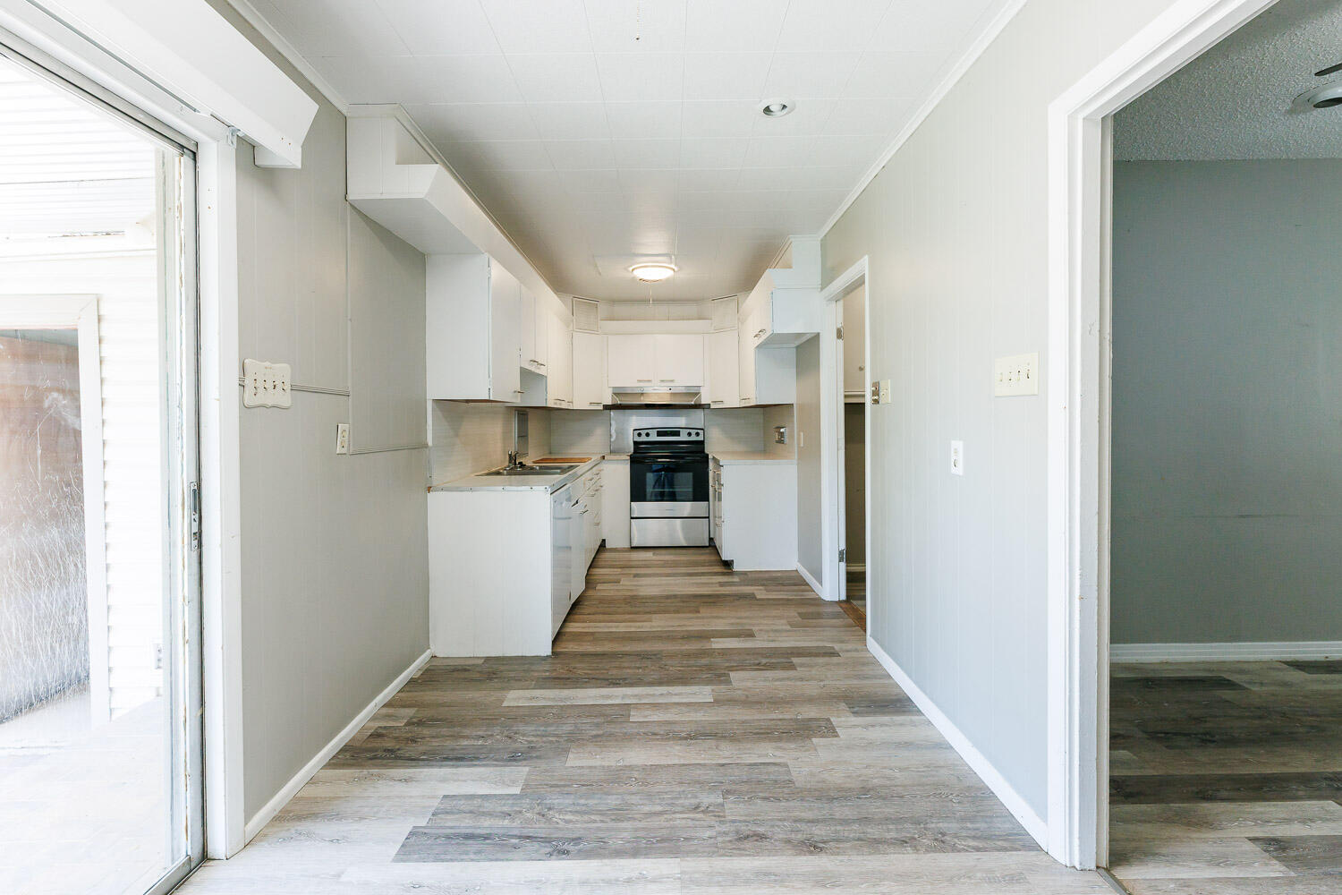 2417 37th Street Lubbock, TX 79412 - Photo 13 of 35 a view of kitchen with wooden floor and electronic appliances