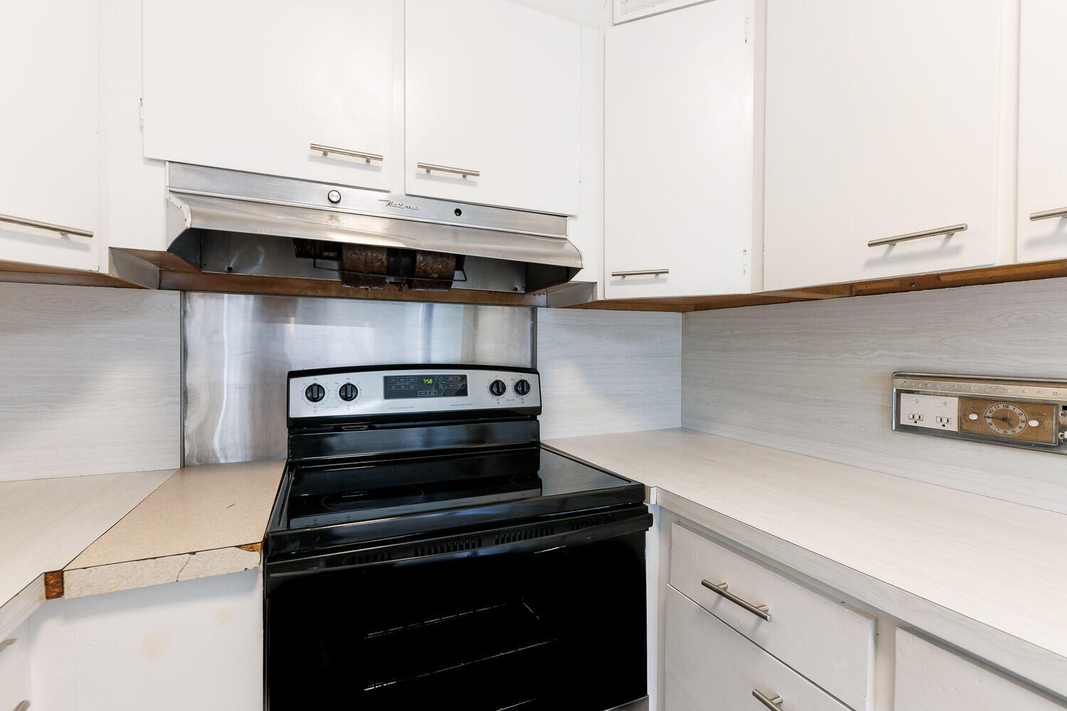 2417 37th Street Lubbock, TX 79412 - Photo 15 of 35 a stove top oven sitting inside of a kitchen