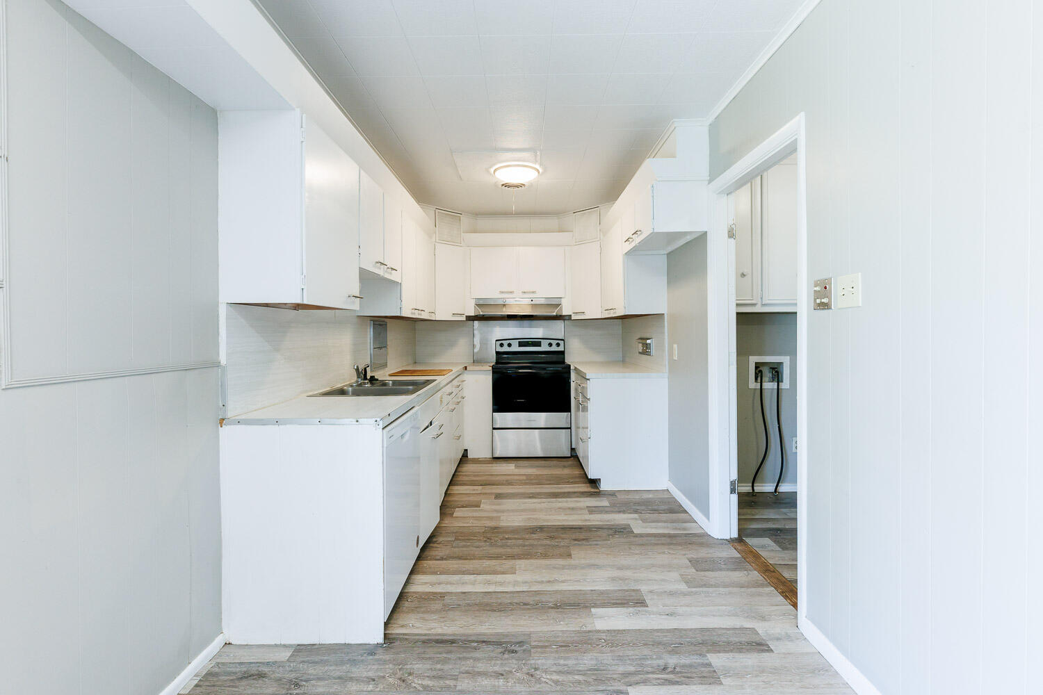 2417 37th Street Lubbock, TX 79412 - Photo 17 of 35 a kitchen with kitchen island white cabinets and stainless steel appliances