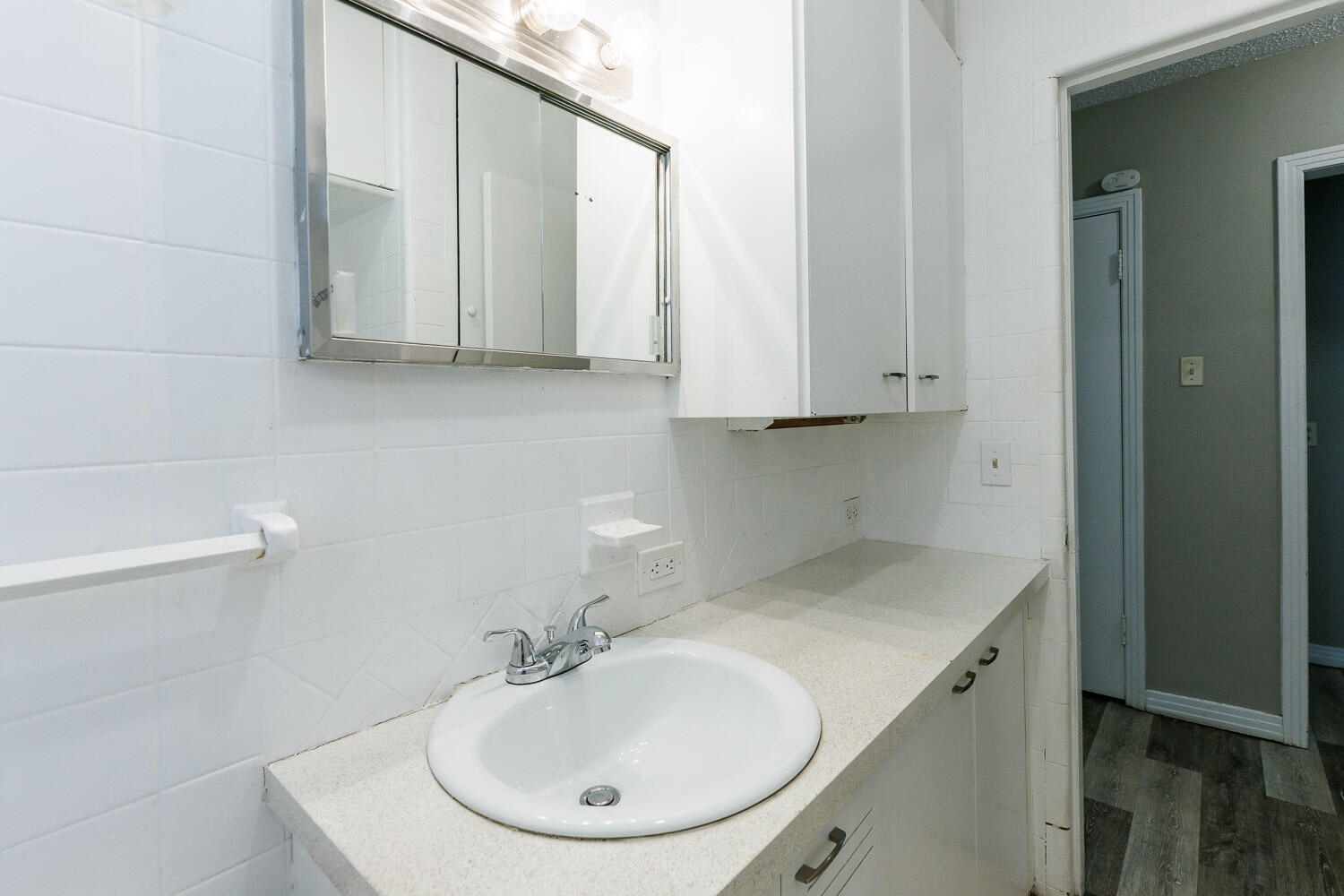2417 37th Street Lubbock, TX 79412 - Photo 26 of 35 a bathroom with a sink and a mirror