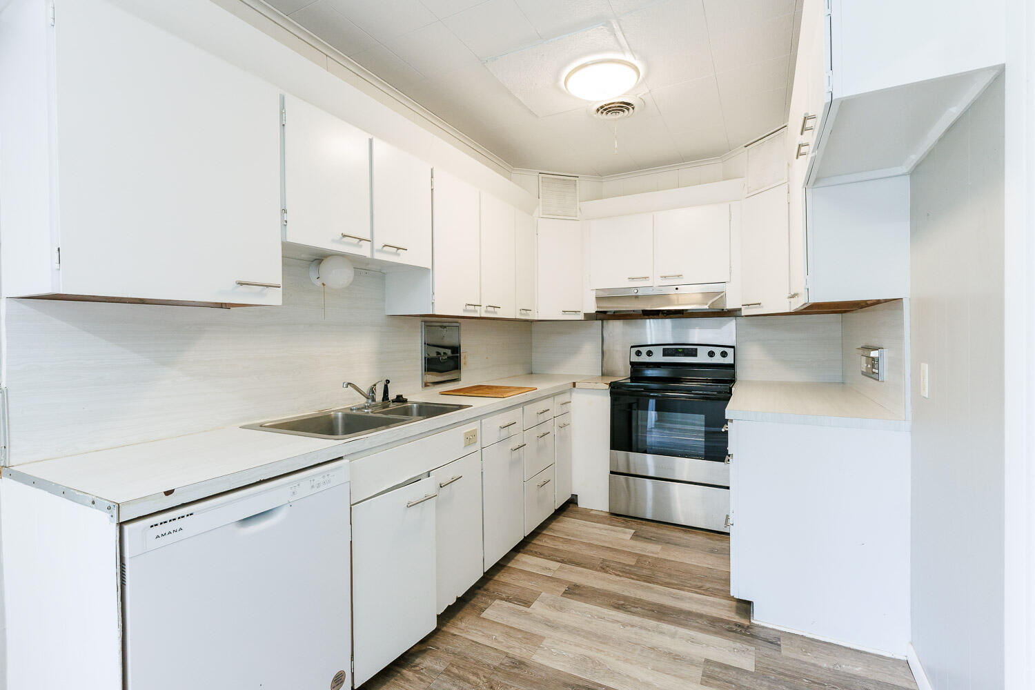 2417 37th Street Lubbock, TX 79412 - Photo 4 of 35 a kitchen with cabinets appliances a sink and a counter space