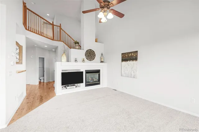 a view of a livingroom with a fireplace and fan