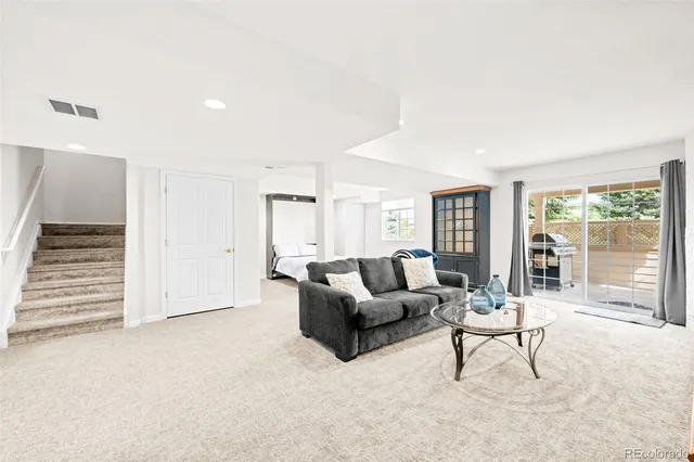 a living room with furniture and a ceiling fan