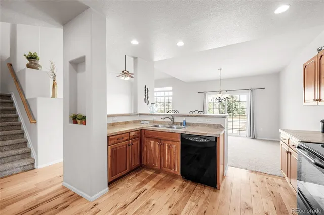 a kitchen with stainless steel appliances granite countertop a stove cabinets and wooden floor
