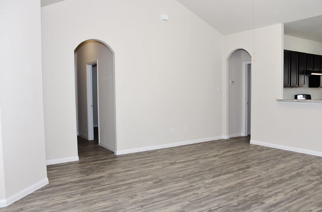 12243 Dona Lane Houston, TX 77044 - Photo 12 of 17 an empty room with wooden floor and a window