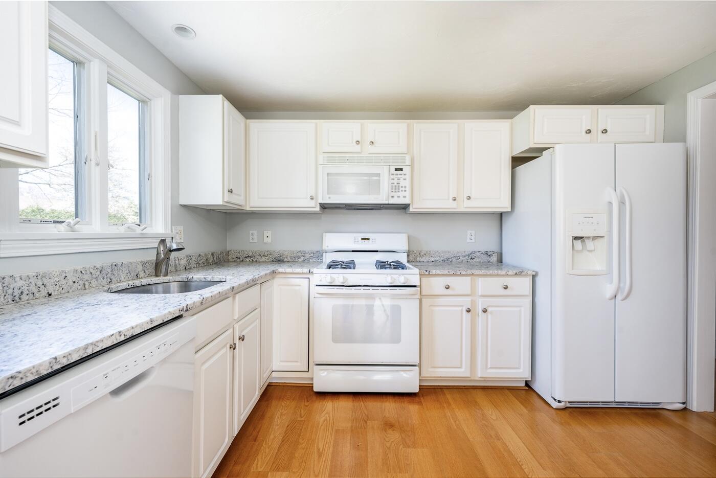 15 Beacon Court Mashpee, MA 02649 - Photo 5 of 33 a kitchen with granite countertop white cabinets and white appliances
