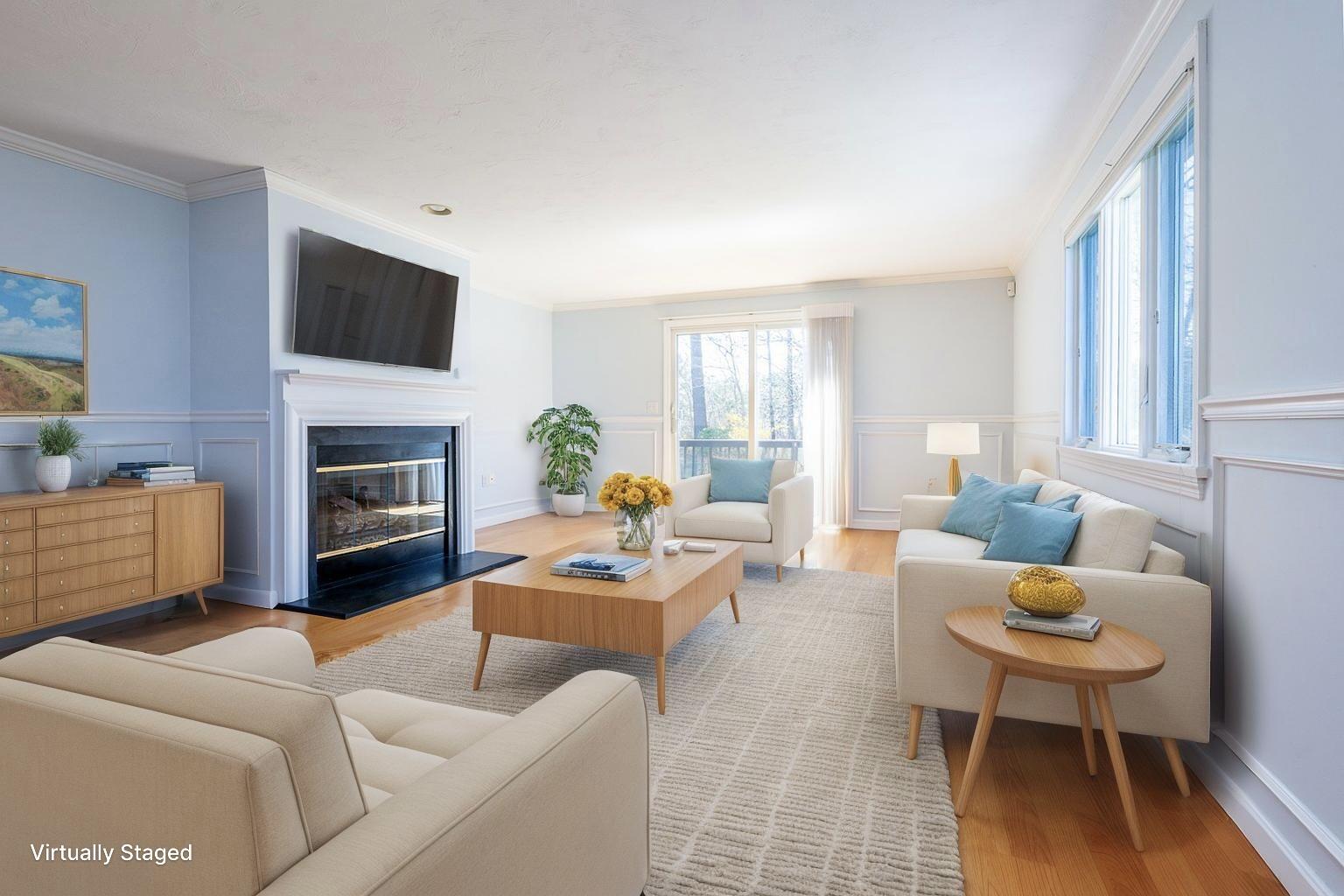 15 Beacon Court Mashpee, MA 02649 - Photo 8 of 33 a living room with furniture a fireplace a flat screen tv and a large window