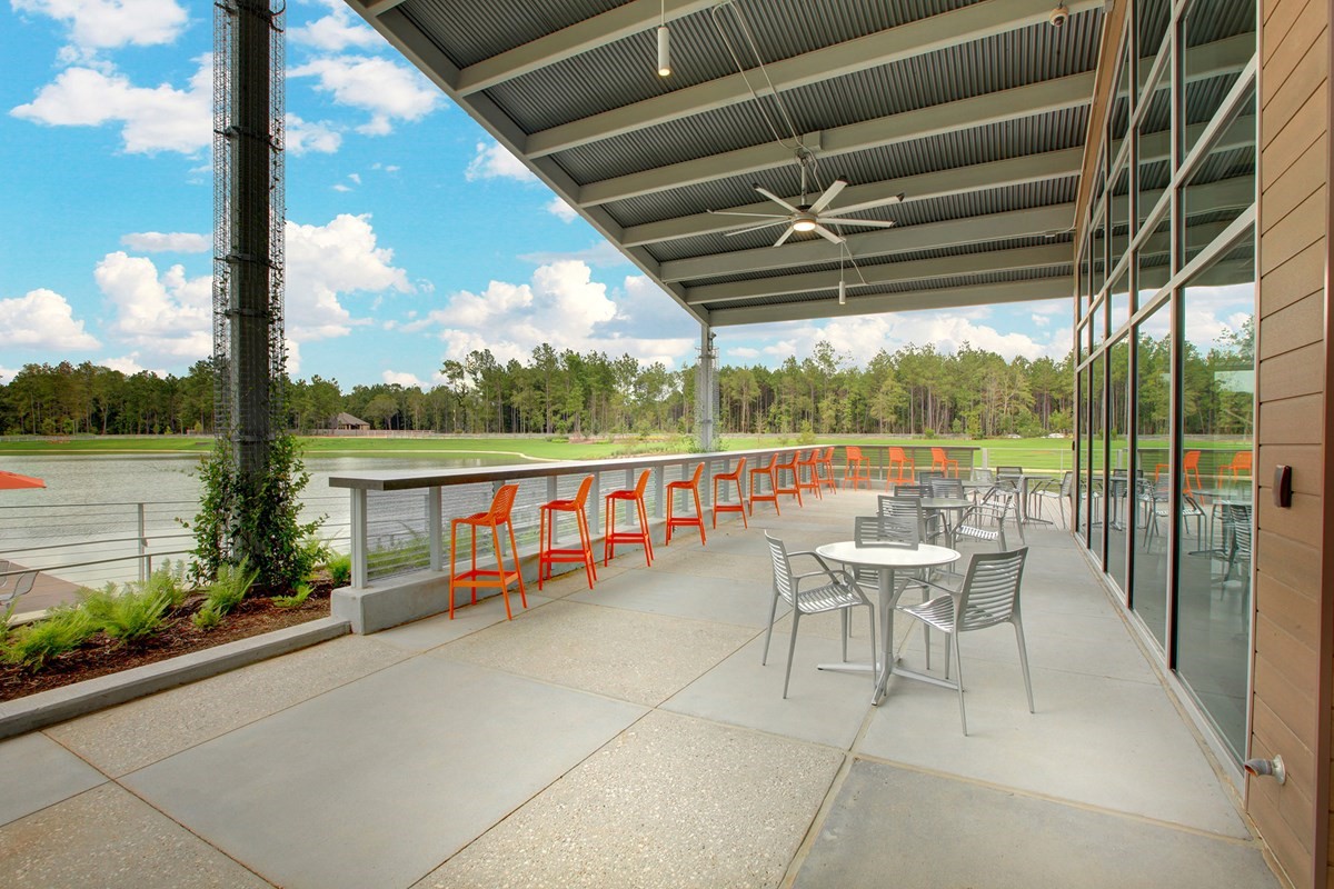 15730 Terracotta Terrace Conroe, TX 77302 - Photo 8 of 14 a view of a chairs and table in patio with a lake view