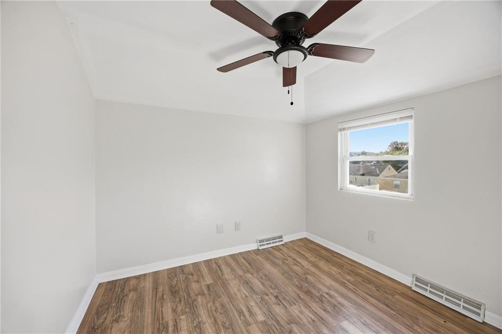 5 Rosamond Street McKees Rocks, PA 15136 - Photo 11 of 17 an empty room with a window and a ceiling fan
