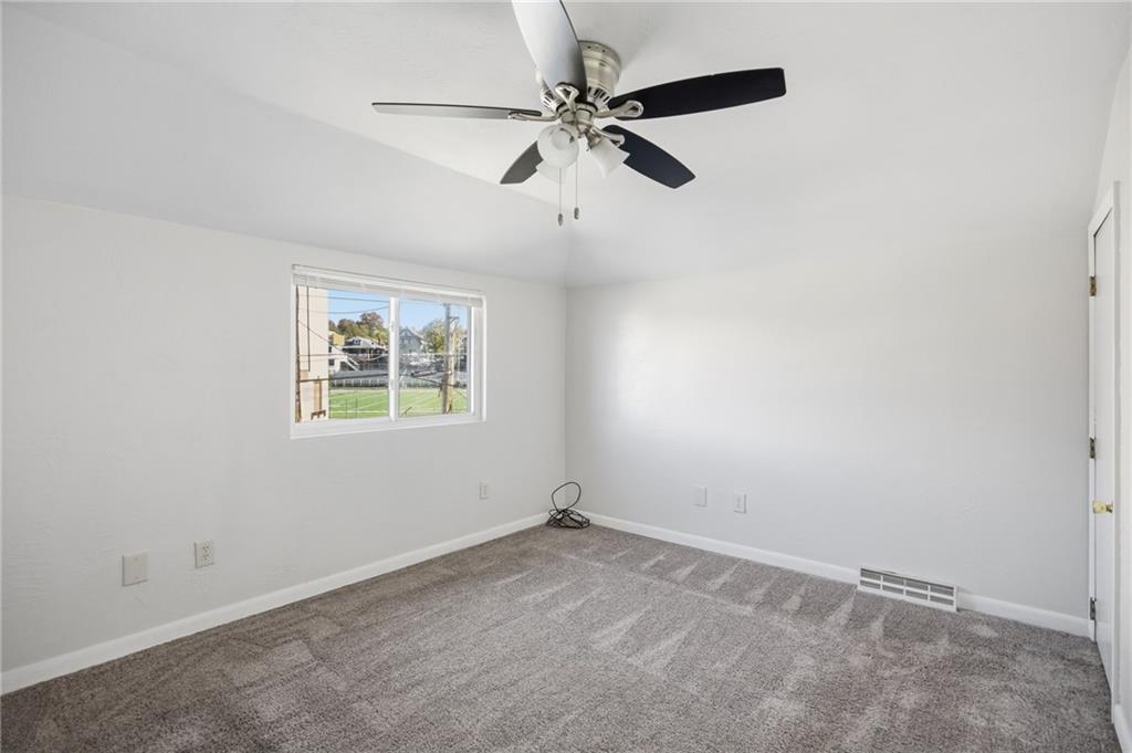 5 Rosamond Street McKees Rocks, PA 15136 - Photo 13 of 17 an empty room with a window and a fan