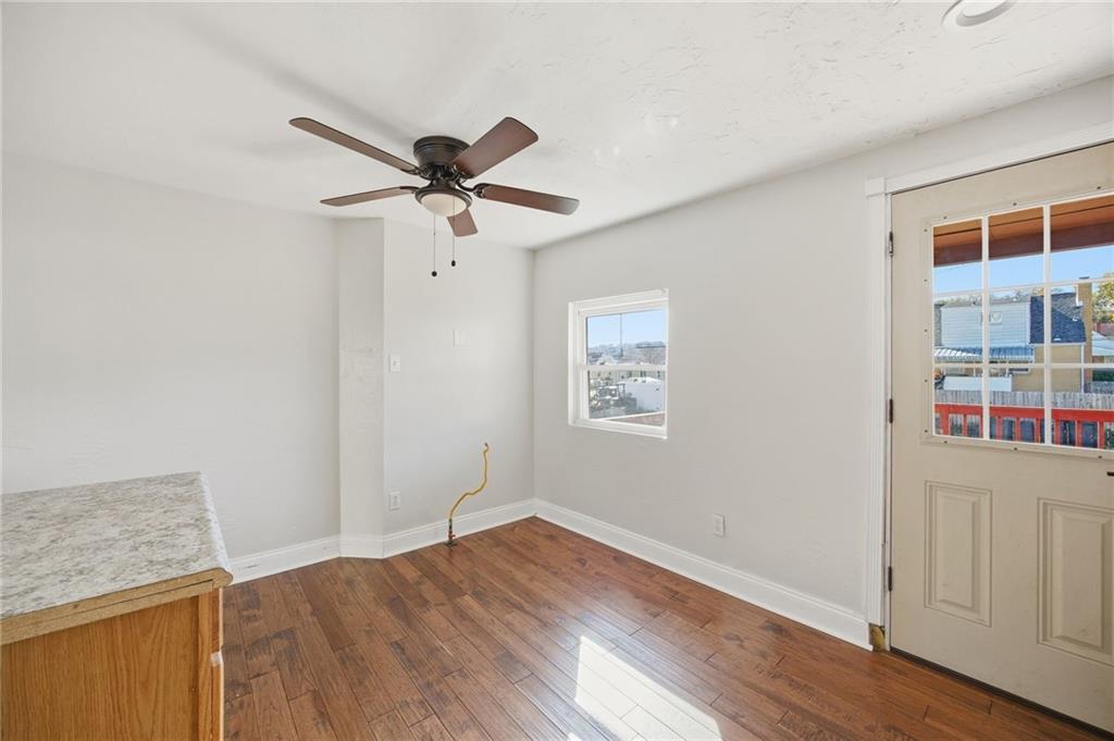 5 Rosamond Street McKees Rocks, PA 15136 - Photo 5 of 17 an empty room with wooden floor and fan