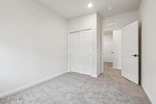 an empty room with closet area