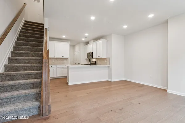 a view of kitchen with wooden floor and electronic appliances