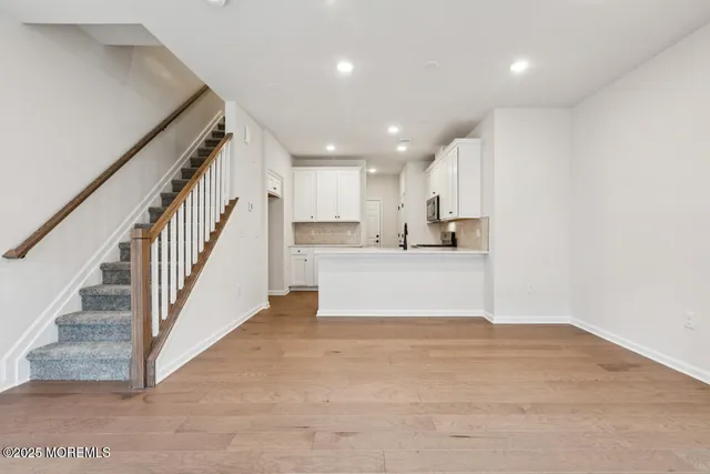 a view of kitchen with wooden floor and electronic appliances