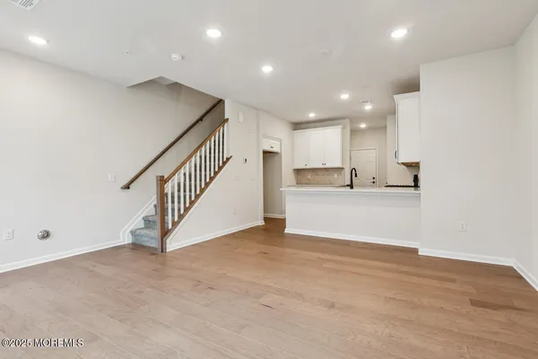 a view of kitchen and hall with wooden floor