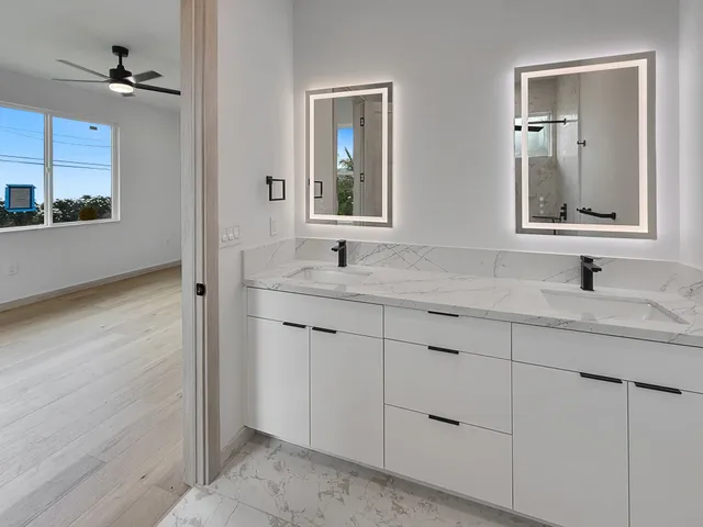 a bathroom with a double vanity sink and mirror