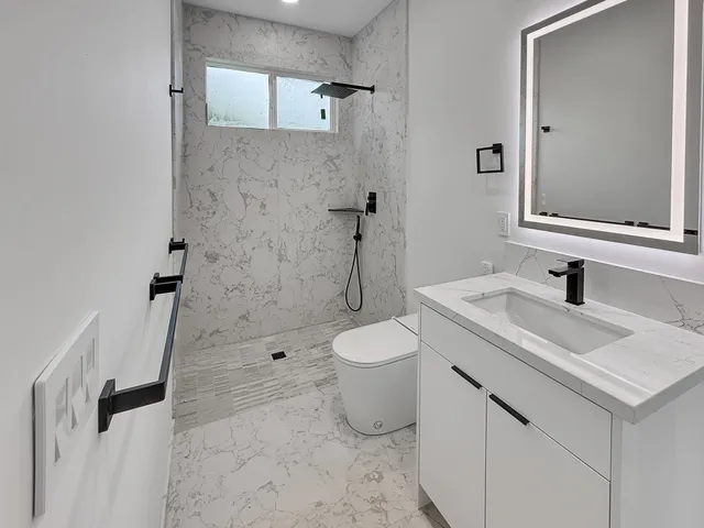 a bathroom with a sink toilet and shower