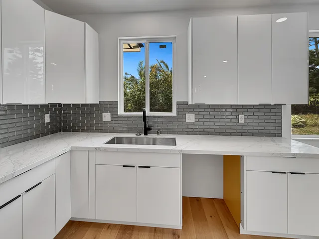 a kitchen with a sink cabinets and wooden floor