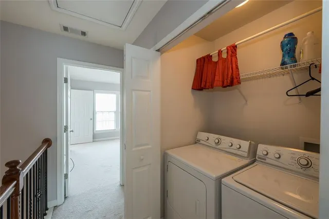 a view of storage and utility room with washer and dryer