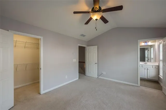 an empty room and chandelier fan