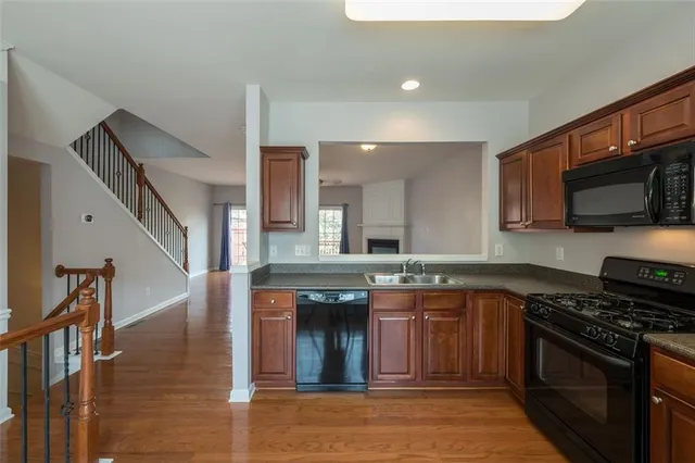 a kitchen with stainless steel appliances granite countertop a stove and a sink