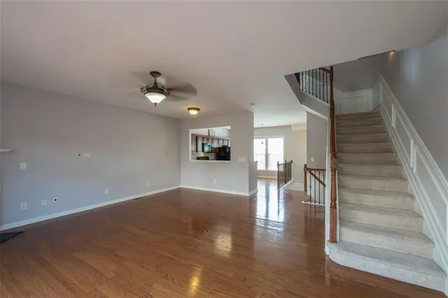 a view of entryway and hall with wooden floor