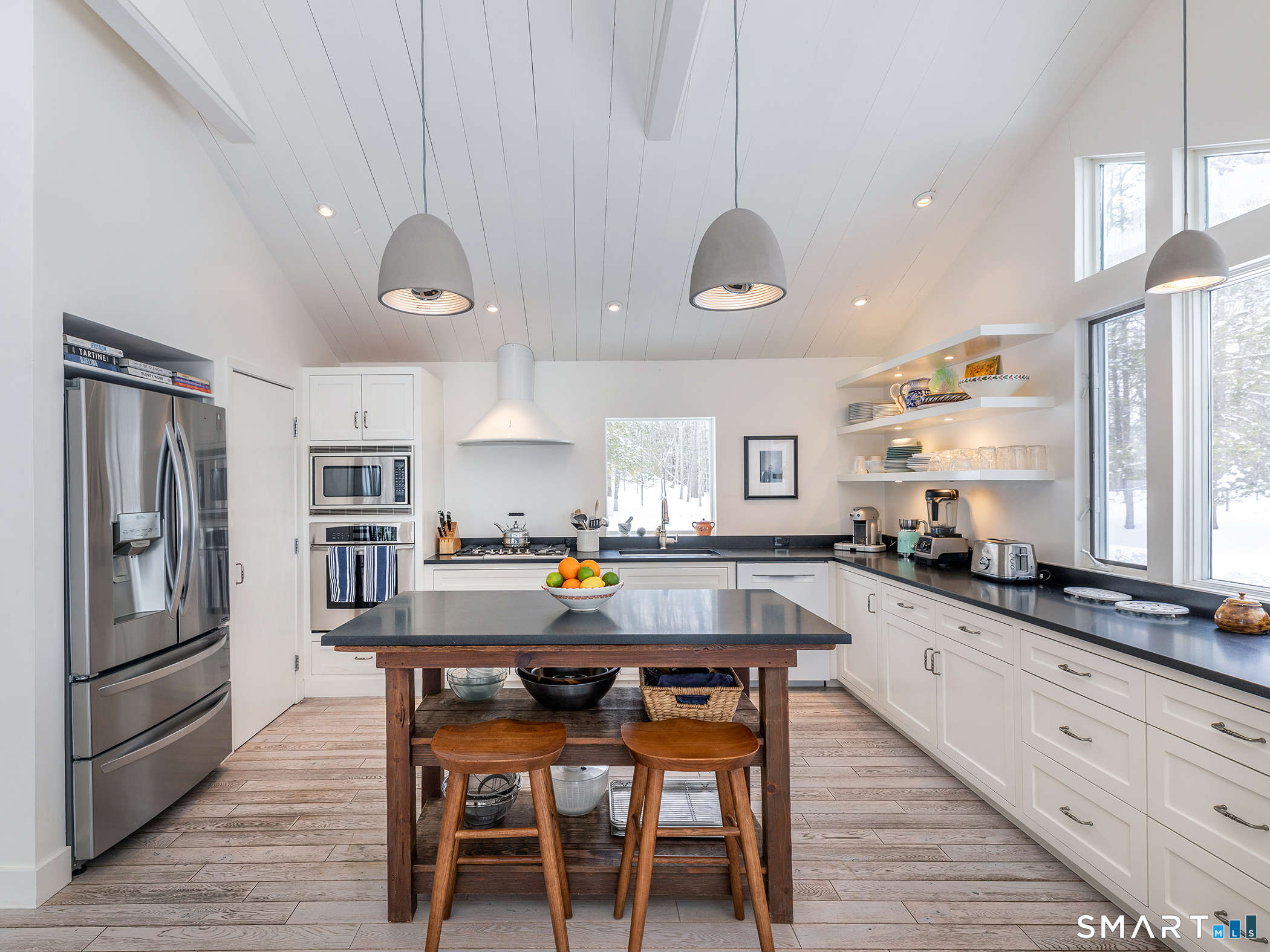 63 West Mountain Road Washington, CT 06793 - Photo 18 of 31 a kitchen with granite countertop a stove a sink a dining table and chairs
