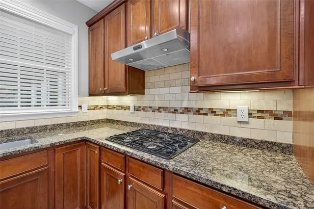 a view of a bedroom with wooden floor and windows