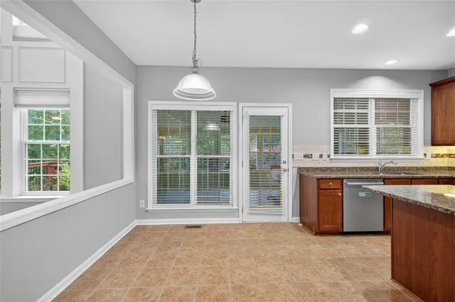 a view of an empty room with a fireplace and a window