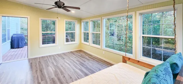 a view of staircase with wooden floor and a rug