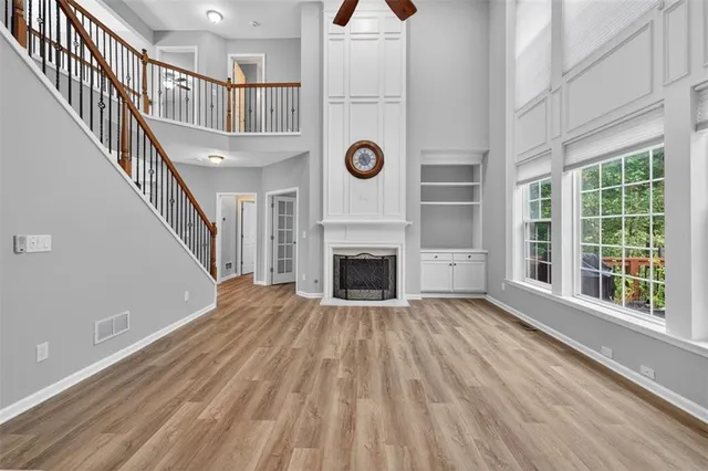 an empty room with closet and fan