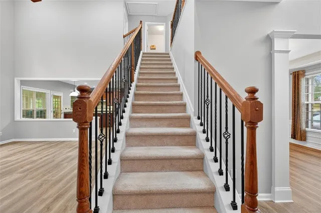 a view of an empty room with chandelier fan