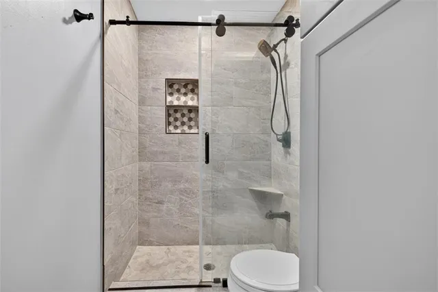 a spacious bathroom with a tub sink shower and mirror