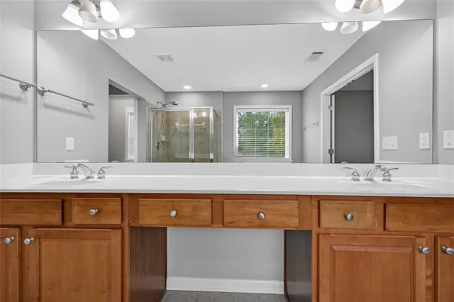 a view of an entrance to house with yard and deck