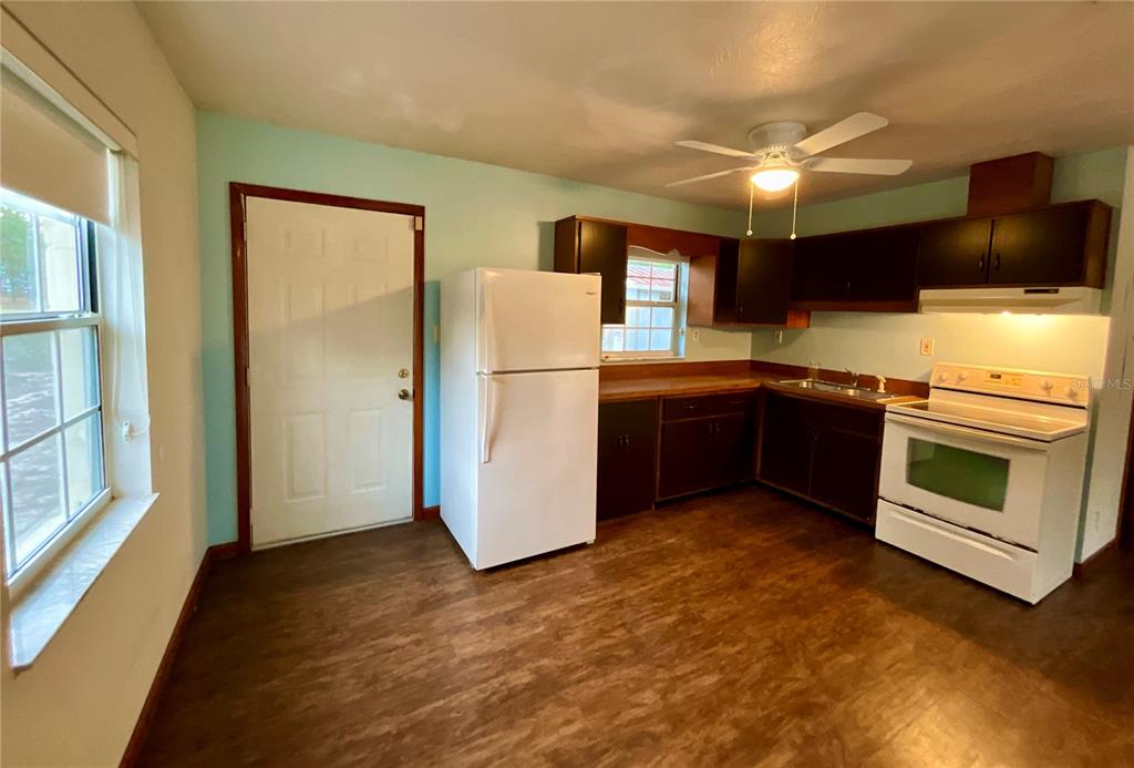 600 Wakulla Street Florahome, FL 32140 - Photo 12 of 47 a kitchen with stainless steel appliances a stove a refrigerator and a sink