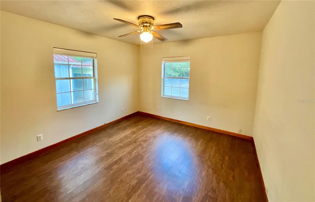 600 Wakulla Street Florahome, FL 32140 - Photo 14 of 47 a view of an empty room with wooden floor and a window