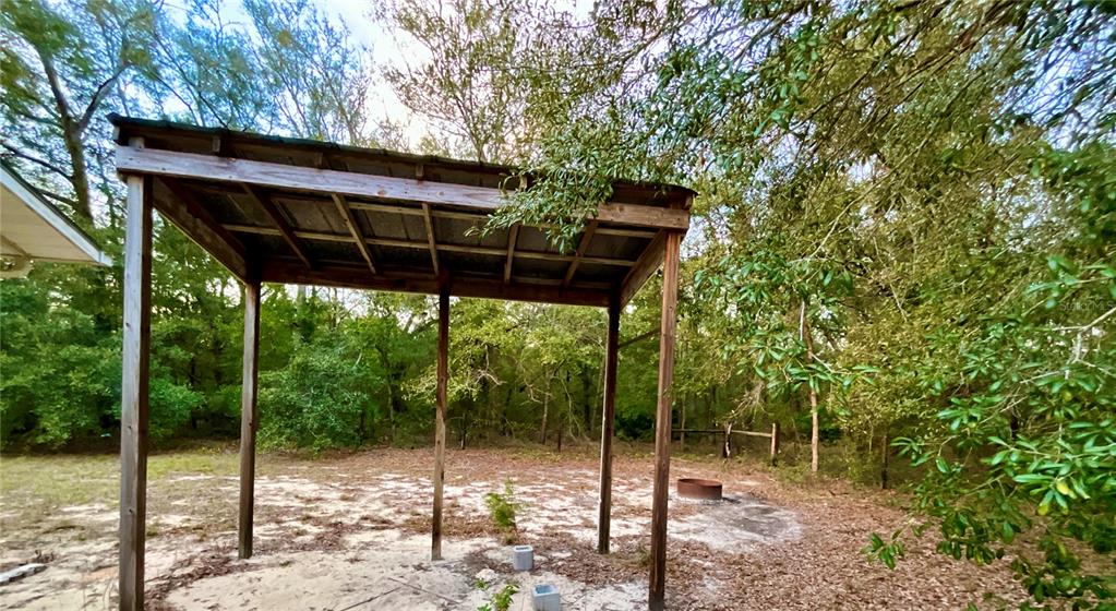600 Wakulla Street Florahome, FL 32140 - Photo 16 of 47 a backyard of a house with table and chairs